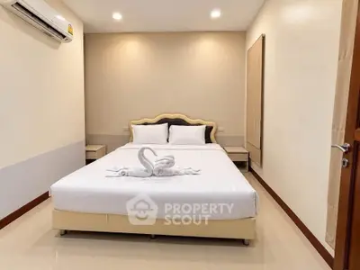 Cozy bedroom with elegant decor and air conditioning, perfect for relaxation.