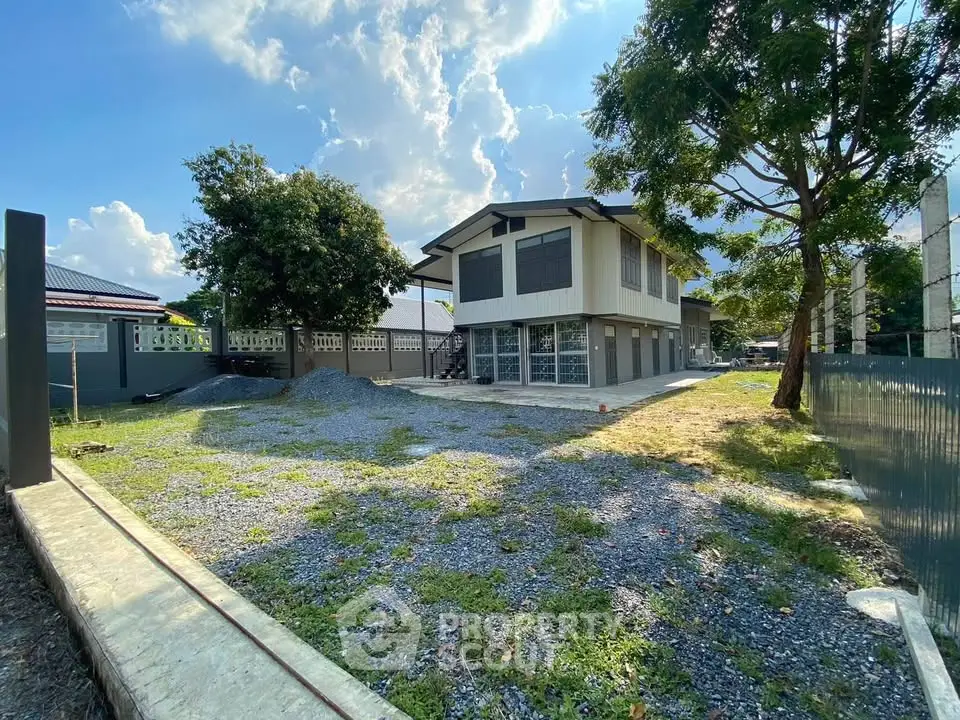 Spacious two-story house with large yard and modern design, perfect for family living.