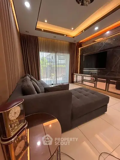 Luxurious living room with elegant decor and large sectional sofa, perfect for relaxation and entertainment.
