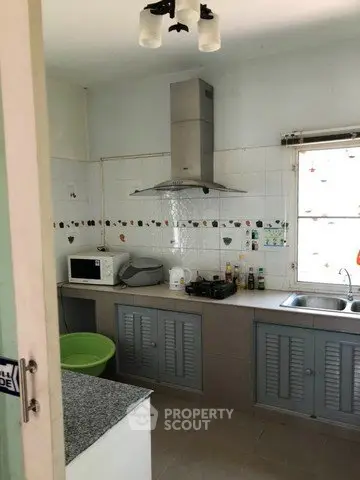 Cozy kitchen with gas stove and ample storage space in a charming home.