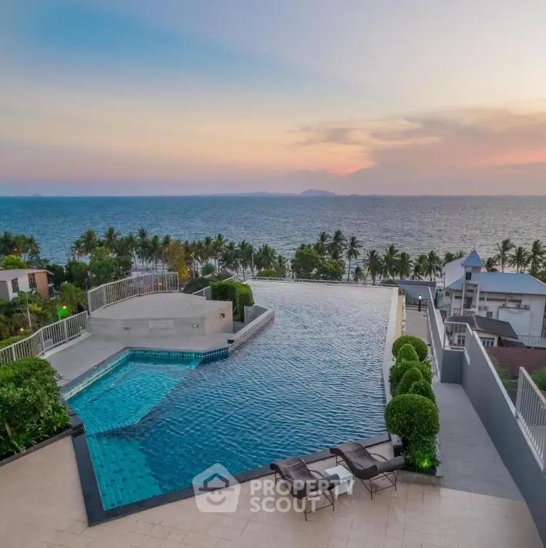 Stunning infinity pool with breathtaking ocean view at sunset, perfect for luxury living.