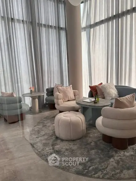 Luxurious modern living room with elegant furniture and floor-to-ceiling windows.