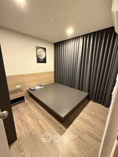 Modern minimalist bedroom with sleek design and moon artwork