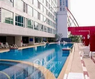 Luxurious apartment complex with stunning poolside view and modern architecture.