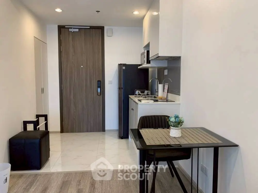 Modern compact kitchen with dining area in stylish apartment