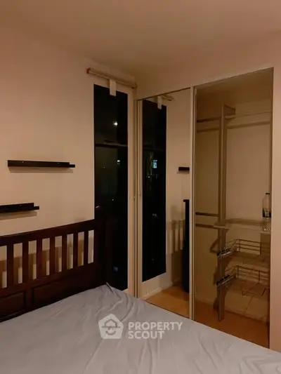 Cozy bedroom with mirrored closet and modern shelving