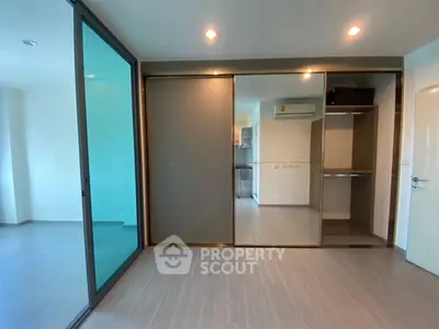 Modern bedroom with sliding glass doors and built-in wardrobe