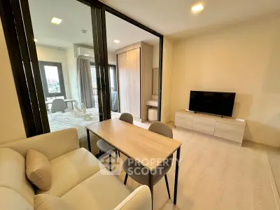 Modern open-plan living room with dining area and bedroom in a stylish apartment