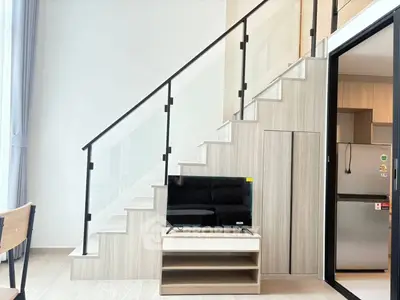 Modern duplex apartment with stylish staircase and sleek kitchen design