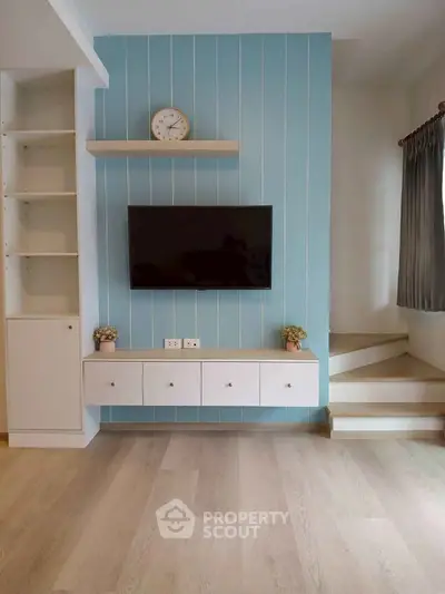 Modern living room with stylish TV wall and wooden flooring