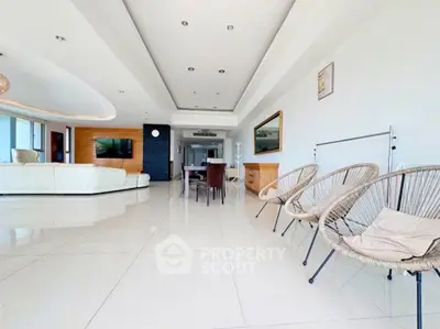 Spacious modern living room with elegant decor and ample natural light.