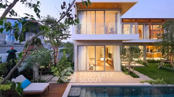 Stunning modern villa with pool and lush garden, featuring floor-to-ceiling windows and elegant design.