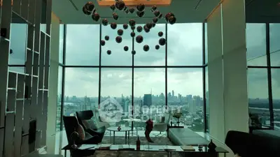 Luxurious high-rise living room with panoramic city views and modern decor.