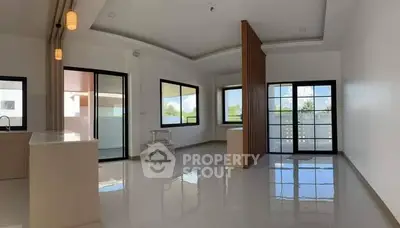 Spacious modern living room with large windows and sleek design.