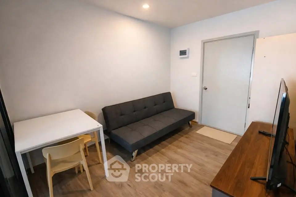 Cozy living room with modern sofa and dining area in compact apartment