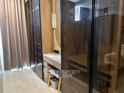 Elegant bedroom with wooden wardrobe and vanity in modern apartment