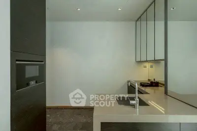 Modern kitchen with sleek design and high-end appliances, featuring a minimalist aesthetic.