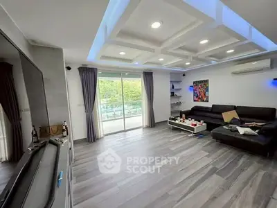 Spacious modern living room with sleek design and large windows