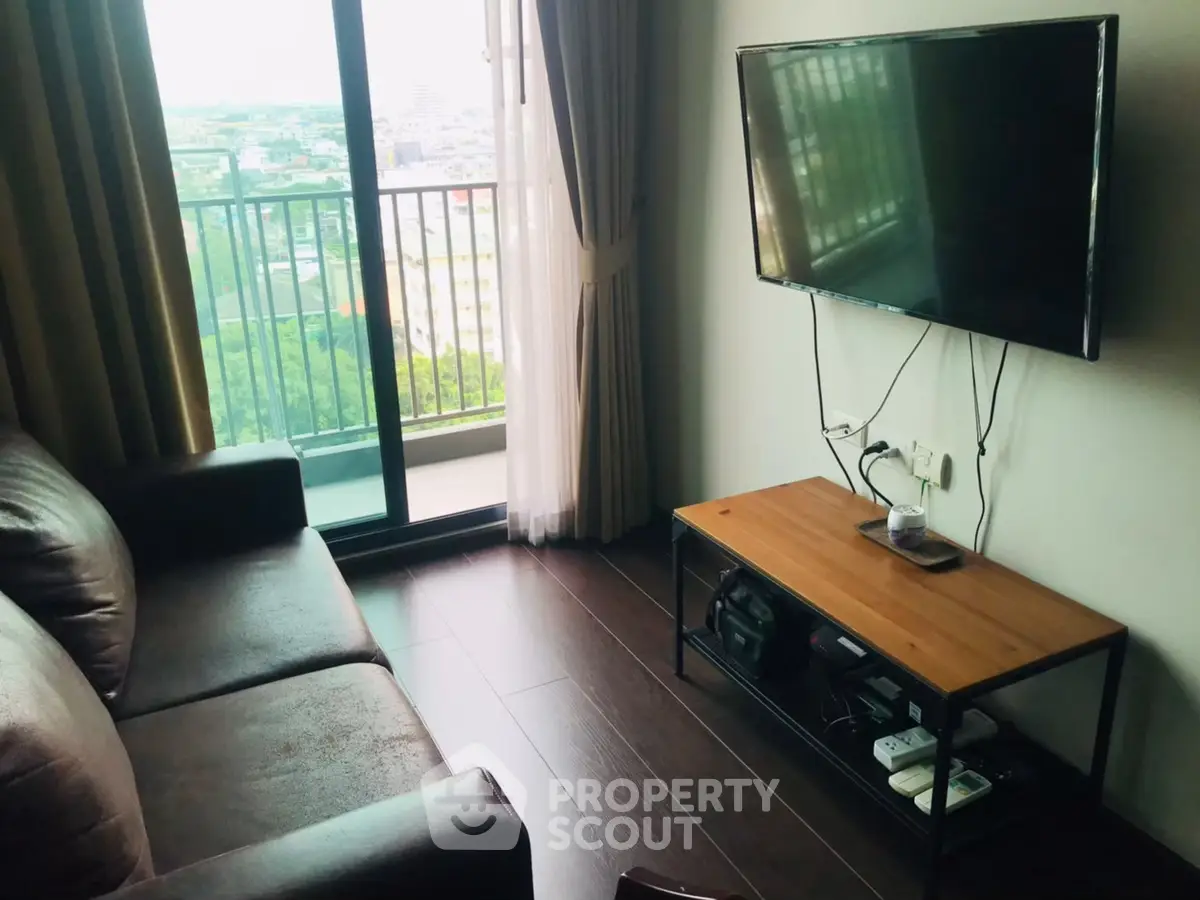Modern living room with balcony view and wall-mounted TV
