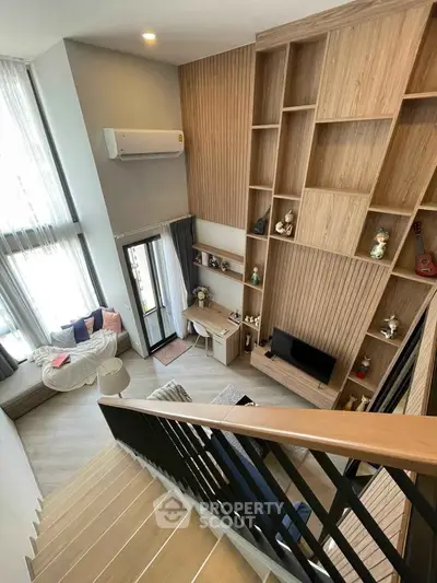 Modern duplex living room with high ceilings and stylish wooden shelving