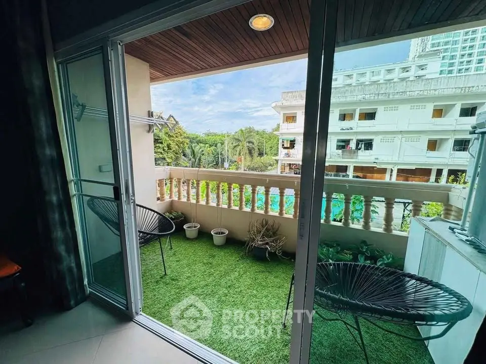 Charming balcony with lush green view, perfect for relaxation and enjoying outdoor moments.