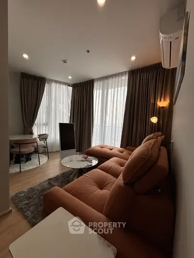Modern living room with stylish furniture and large windows for natural light