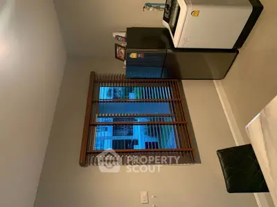 Modern kitchen with sleek appliances and large window overlooking garden