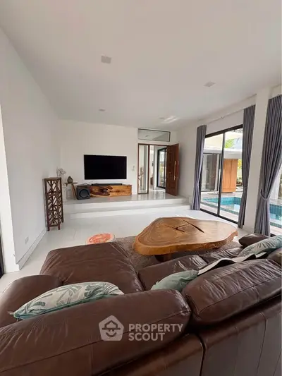 Spacious living room with pool view and modern decor