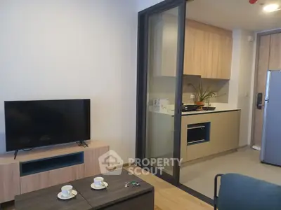 Modern living room with open kitchen and sleek appliances