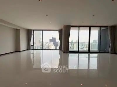 Spacious modern living room with floor-to-ceiling windows and city view