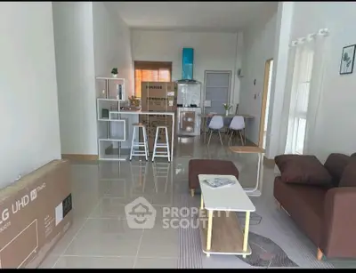 Modern open-plan living room with sleek kitchen and stylish furniture, perfect for contemporary living.