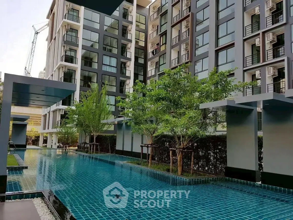 Modern condominium with stunning pool and lush greenery