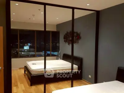 Spacious bedroom with city view and modern decor in luxury apartment