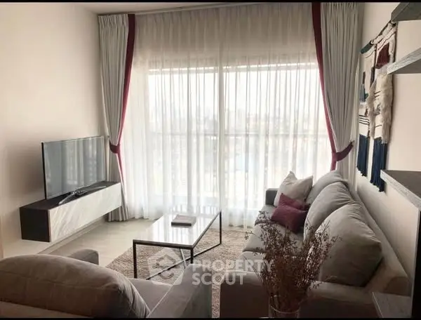 Elegant living room with modern decor and large window view