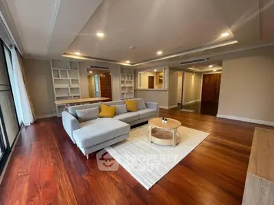 Spacious living room with modern decor and hardwood floors in luxury apartment.