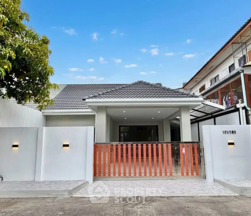 Charming single-story home with modern facade and gated entrance in a serene neighborhood.