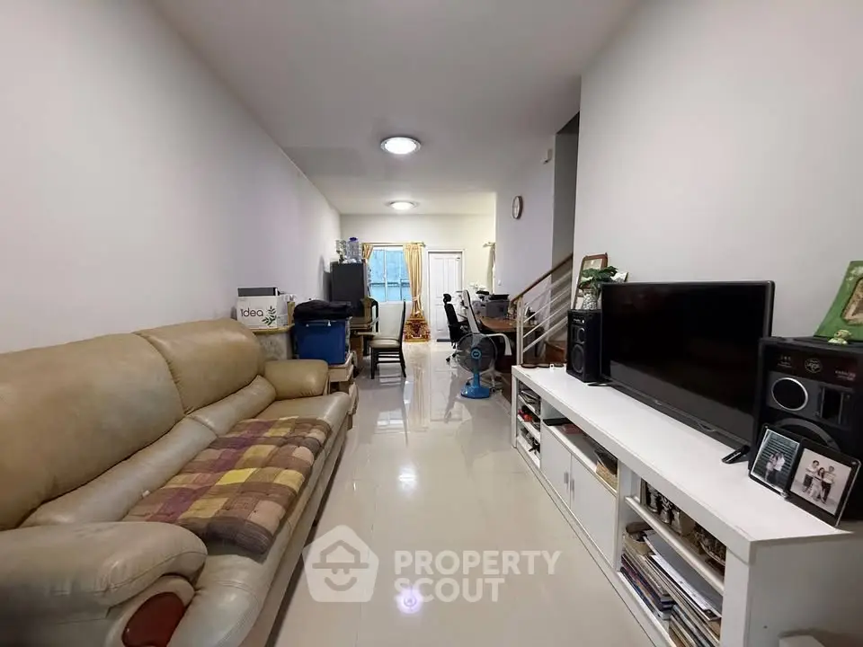 Spacious living room with modern decor and entertainment center, perfect for relaxation and gatherings.