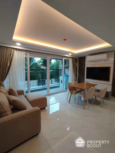 Luxurious living room with modern decor and spacious balcony view