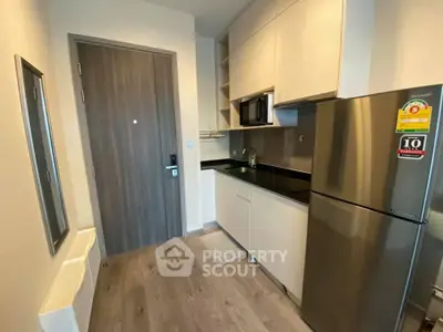 Modern kitchen with sleek cabinets and stainless steel appliances in a compact layout.