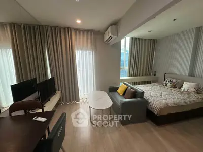 Modern studio apartment with cozy living area and stylish decor