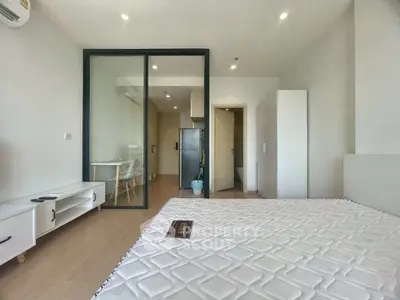 Modern studio apartment with glass partition and sleek furnishings