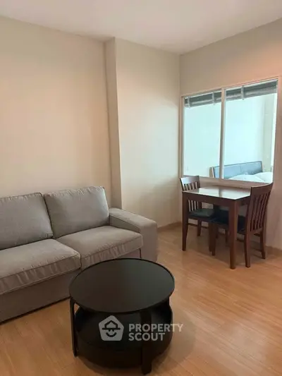 Cozy living room with modern furniture and natural light, perfect for relaxation and entertaining.