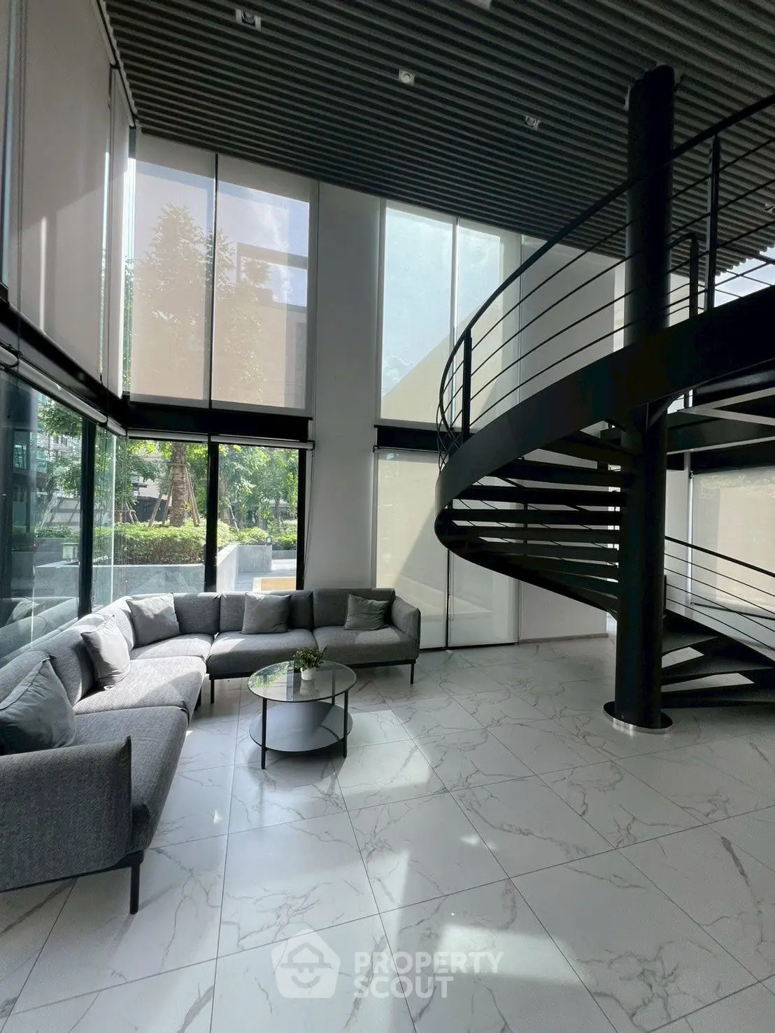 Modern living room with spiral staircase and large windows