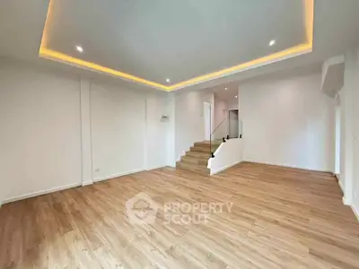 Spacious modern living room with elegant recessed lighting and wooden flooring