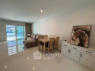 Spacious living room with modern furniture and elegant decor in a bright home.