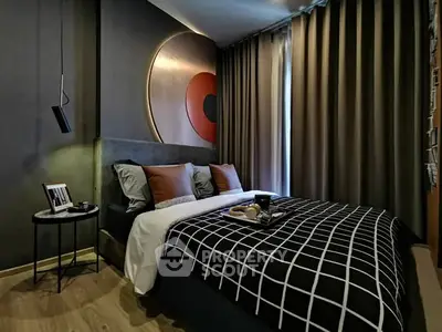 Modern bedroom with stylish decor and cozy ambiance, featuring elegant lighting and contemporary artwork.