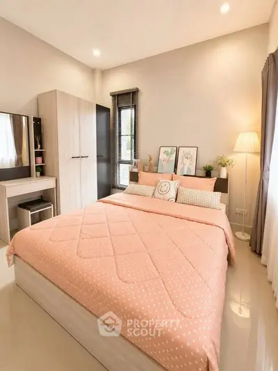 Cozy bedroom with modern decor and ample natural light, featuring a stylish bed and elegant furnishings.
