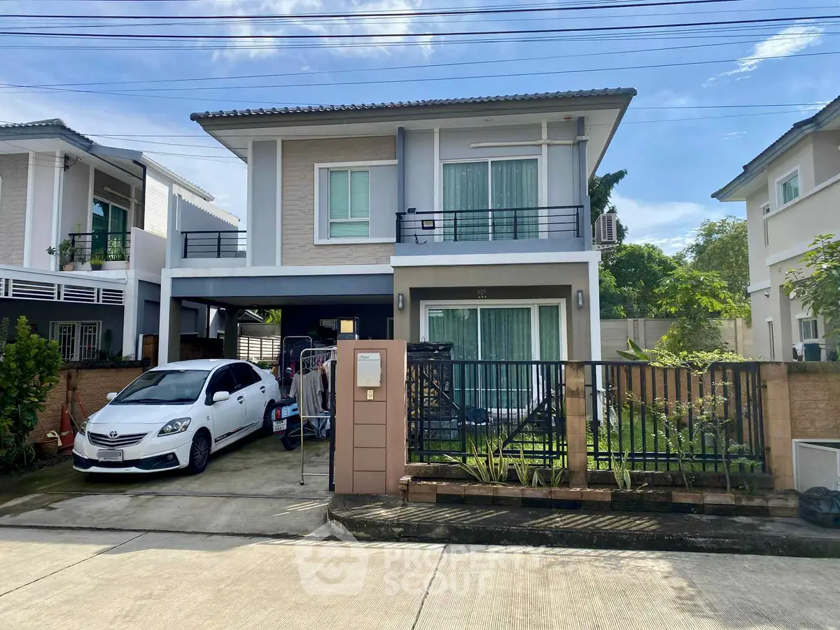 Charming two-story house with driveway and car, modern design, in a serene neighborhood.