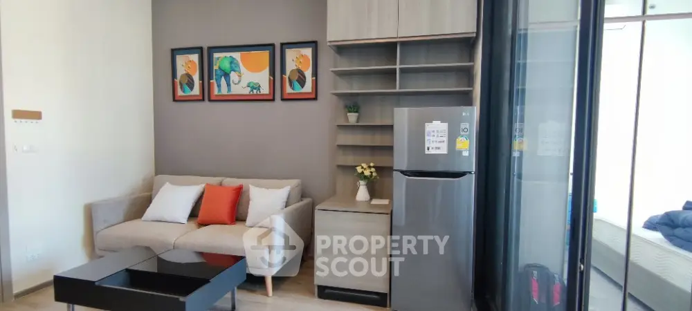 Modern living room with stylish decor and compact kitchen area