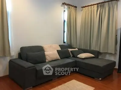 Cozy living room with stylish gray sectional sofa and elegant curtains